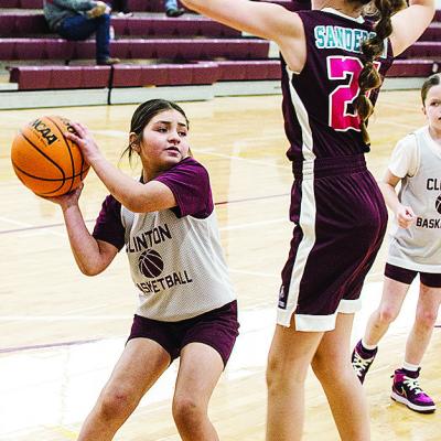 Maddi Esquivel, left, avoids the Sayre defender during Clinton’s fourth-grade girls’ basketball game at the practice gym. CDN |Sam Goodwyn