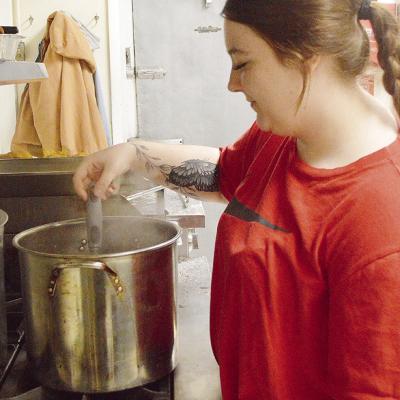 Cook Abbey Shields stirs up a pot of ground beef while preparing a meal for people in her new role helming the kitchen of the Clinton Mission House. CDN | Micah Ashcraft