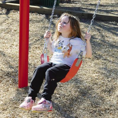 Elizabeth Field, 5, plays on a swing at ACME Park. CDN | Michael Maresh