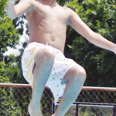 Kaileb Tyler starts his forward facing backflip into the Clinton Public Pool. CDN | Christian Jacobsen