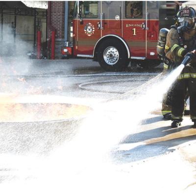 Firefighter Alex Tyler, left, and Capt. Forrest Valentine conduct foam fire retardant tests at the Clinton Fire Department. CDN | Caleb Blanchard Fire exercises