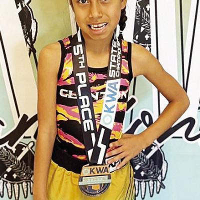 Adelynn Lonebear smiles after finishing fifth in the 8U 47-pound class during the OKWA State Wrestling Tournament in Oklahoma City over the weekend. CDN |Courtesy Photo