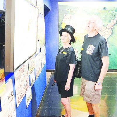 Lynn Partridge-Webber, left, and her husband Roger examine an exhibit at the Oklahoma Route 66 Museum while they take a trip down the Mother Road while visiting from the UK. CDN | Sam Goodwyn