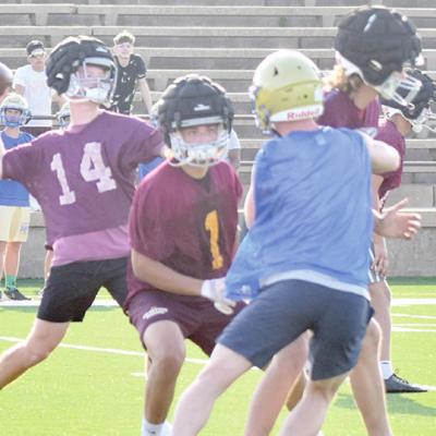 Cooper Sulley looks down the field and throws the ball to a wide receiver while Kaleb Edwards and Tanner Bartlett block for Sulley during Clinton’s 7-on-7. CDN | Josh Jennings CHS football participates in 7-on-7 drills