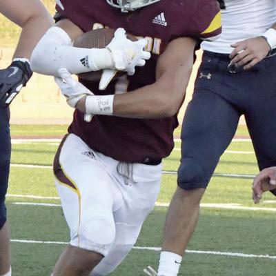 Caleb Edwards tucks the football and jukes through defenders during a recent game. CDN | John Kinsey Edwards feels privileged to play football