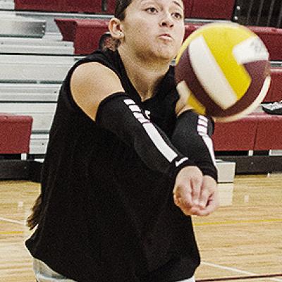 Clinton’s Aaliyah Lopez returns the ball back over the net during practice in the practice gym. CDN | Sam Goodwyn
