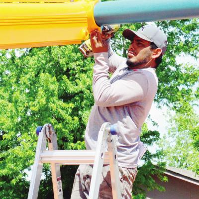 Oscar Hidalgo, of Oklahoma City ACS Playground Adventures, puts together a piece of new playground equipment at McLain Rogers Park. The new playground is expected to be completed in early June. CDN | Collin Wieder City will fund remainder of park project