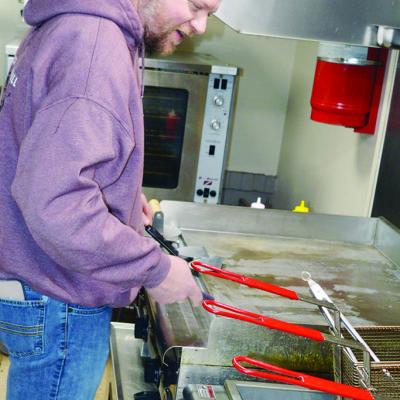 Split Decision and Grill co-owner Clint Lively prepares to cook for lunch one day at the restaurant. CDN | Michael Maresh