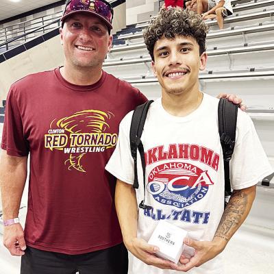 Clinton’s Tristan Cardenas, right, smiles with Clinton wrestling coach Rhett Blundell after competing in the All-State Wrestling Match Thursday at Edmond North High School. CDN | Courtesy photo