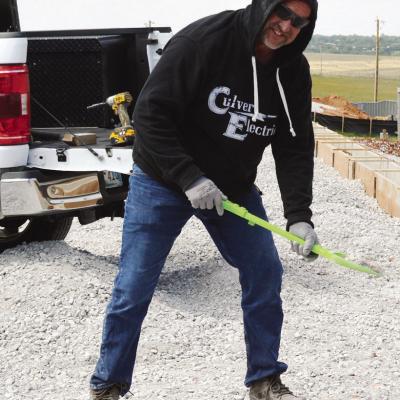 Subcontractor Jeremy Fisher spreads out rock and gravel using Bryler Daggs’ shovel recently at the Clinton Regional Airport. Daggs, his grandson, placed the shovel into his work truck and told him, “I’ll let you use my shovel at work.” CDN | Chris