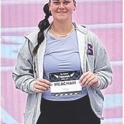 Clinton’s Kat Meacham shows off her badge prior to her competing last month in the New Balance Indoor Nationals in Boston. CDN | Courtesy photo CHS track athletes find ways to deal with national events
