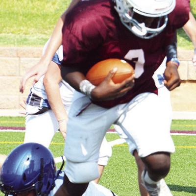 Seventh-grader Trenair Collins avoids a Newcastle defender as he runs into the endzone during the scrimmage Friday at the Tornado Bowl. CDN | Sam Goodwyn Rising Stars