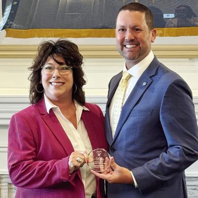 Jackie Aaron, left, executive director of CASA of Western Oklahoma, presents the Champions of Children Award to Rep. Anthony Moore. CDN | Courtesy photo