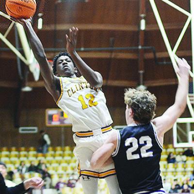 Clinton’s Atticus Thompson flies through the air for the layup during the Reds’ game against Bethany last year in the Tornado Dome. CDN | Sam Goodwyn Clinton’s Atticus Thompson flies through the air for the layup during the Reds’ game against Bethany last year in the Tornado Dome. CDN | Sam Goodwyn