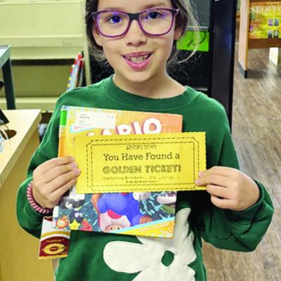 Nellie Brinkley shows off her “Golden Ticket” she found tucked away in her library book at Southwest Elementary during Read Across America Week. She and other lucky winners qualify for goodie bags. The school’s library has been engaging students all
