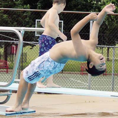 Juan Martinez tries to perform a backflip into the water Thursday at the Clinton Pool during Summer Playground. CDN | Christian Jacobsen