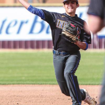 Eric Flores makes a throw to first base