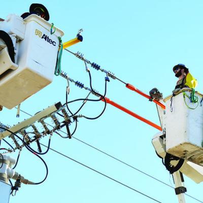 Journeyman lineman Noah Morhiser works on a power line on U.S. Highway 183. CDN | Michael Maresh