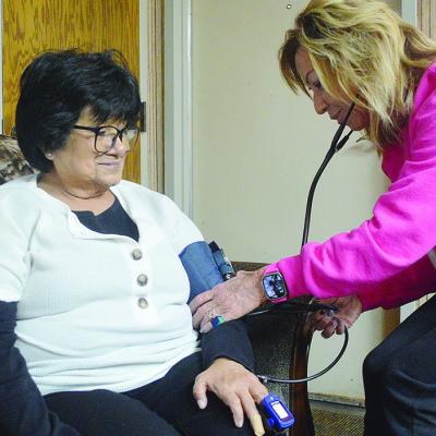 Margaret Castillo, left, gets her blood pressure checked by Tammy Shepherd while at the Shepherd Home, Health, and Hospice offices. CDN | Micah Ashcraft