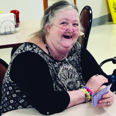 Virginia Caler explains the rules of the 52-card game they are playing called “Trailer Park” at River Valley Therapy Center. CDN | Christian Jacobsen Virginia Caler explains the rules of the 52-card game they are playing called “Trailer Park” at River Valley Therapy Center. CDN | Christian Jacobsen