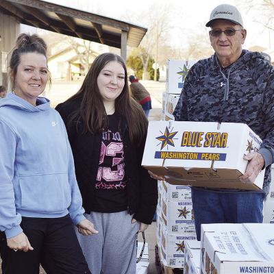 From left, Clinton Mission House Director Jennifer Lee, Abbey Shields, and Board Member Sam Shelton unload a pallet of pears delivered Thursday morning to the Mission House. CDN | Micah Ashcraft