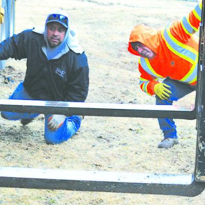 Javier Carrillo, left, works with Jose Torrubiates in directing a forklift to lift a trailer off of a truck Monday morning near SketchSHE on S. Fourth Street/ U.S. Highway 183. The two trailers will be converted to a doctor’s office for a Hamilton Healt