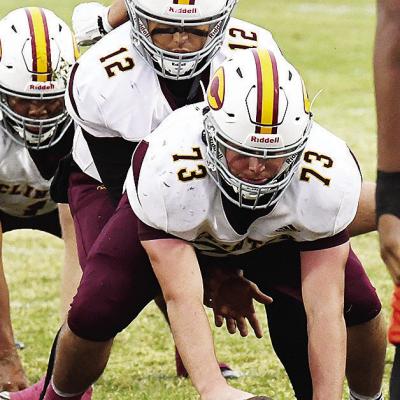No. 73 Joel Badillo prepares to snap the ball to his quarterback No. 12 Sutton Hernandez in Oklahoma City during Clinton’s final regular season game against Douglass. CDN | John Kinsey