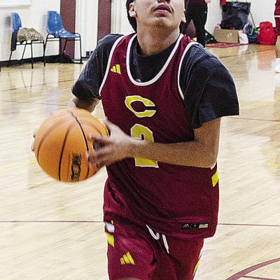 Clinton’s Ronnie Redshin focuses on the basket as he goes up for a layup during a practice in the gym at Southwest Elementary