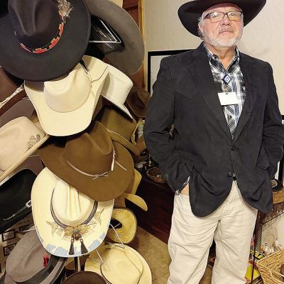 Wearing his favorite hat, Gary Albert stands next to a small portion of his collection. CDN | Shiann Dawson