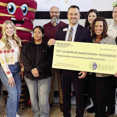 GEAR UP announced Monday the district has received a grant of $34.7 million to assist students who want to go to college. Front row, from left, are CHS Assistant Principal Rachel Ray, board members CaraLea Kreizenbeck and Kim Meacham, Clinton students Gra
