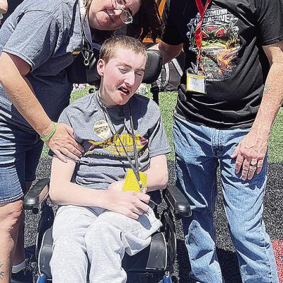Andrew Schantz, center, enjoys the day at Oklahoma State with his mom, Julia, left, and dad Bobby, right, during the Special Olympics Summer State Games. CDN |Courtesy Photo