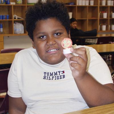 Ian Aguilar shows off his ping pong light made during the Discovery Zone class taught by JoDee Adney Wednesday at Washington Elementary. CDN | Christian Jacobsen