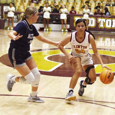 No. 24 Paige Lloyd works the dribble past an Altus defender. The senior enjoys her role of point guard for the Lady Reds. CDN | Emily Stephens Senior directs traffic, team at point guard