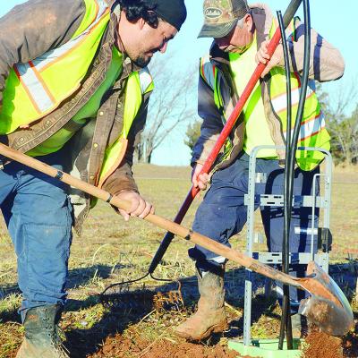 Michael Castillo, left, and Rancho Rodriguez replace and smooth out the dirt after excavating near a utility pole for maintenance Thursday morning on S. 28th Street. CDN | Micah Ashcraft