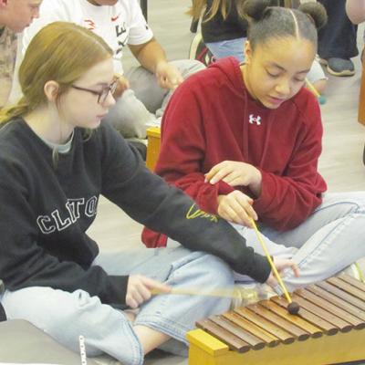 Magnolia Gibson, left, and Genisus Johnson work together on the xylophone to play “Chicken on a Fencepost” at Clinton Middle School. CDN | Christian Jacobsen