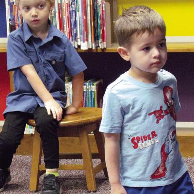 Lincoln Strauch, left, and Elliot Flores are focused on the story “Splish Splash Ducky” being read during storytime at Clinton Public Library. CDN | Christian Jacobsen