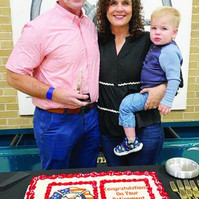 Recently retired Clinton Fire Chief Brett Russell was feted with an award and cake at Tuesday’s Clinton City Council meeting. Joining him are his wife Marci and his grandson Sam Calvert. CDN | Staff Photo