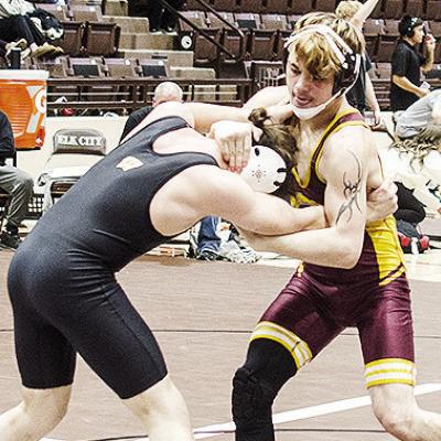 Clinton’s Landon Wilson, right, grapples with his opponent during the Class 4A District Duals Tuesday in Elk City. CDN | Sam Goodwyn