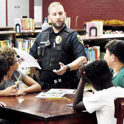 Student Resource Officer and Clinton Police Officer Dillon Whitton teaches the D.A.R.E. Program to sixth graders. From left are Eden Trout, Damarian Bailey, Tradarius Hester, and Barrett Rojo in the Washington Elementary Library. CDN | Caleb Blanchard Just say no