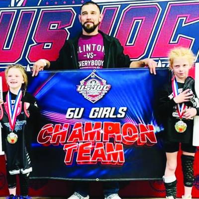 Clinton 6U wrestlers Preslie Dickerson, left, and Stella McCarther, right, celebrate with their coach Jesse Camarillo as they took home the 6U team award during the United States Junior Open Championship this past weekend in Oklahoma City. CDN | Courtesy Rising Stars