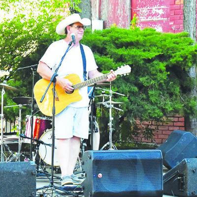 Lead man Dean Jackson covers popular hits with his son, Jordan Jackson, left, on guitar and Chris Roland, right, on bass guitar at Engleman Park for Thursday’s Friends on Frisco. CDN | Caleb Blanchard The Dean Jackson Band