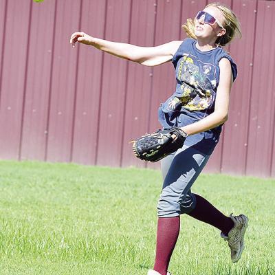Clinton’s Madison Walker hurls the ball toward second base in a drill during practice. CDN | Sam Goodwyn