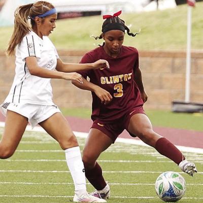 Clinton’s Peyton Clonce, right, tries to avoid the Elk City defender during the Lady Reds’ home game against the Elkettes in the spring. CDN | Steve Wheeler