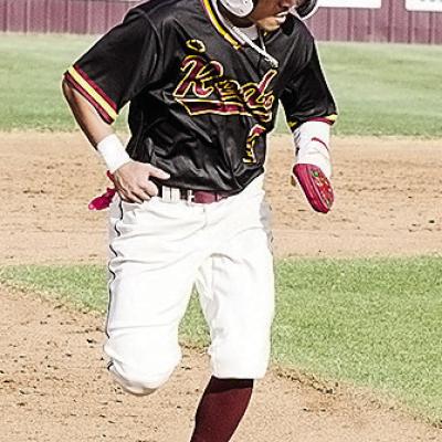Clinton’s Azreal Fierros hustles to third during the Reds’ home game Monday against Woodward. CDN | Sam Goodwyn
