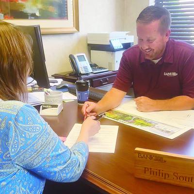 Phillip South uses his expertise as a mortgage loan officer with Bank360 to help a customer. CDN | Shiann Dawson