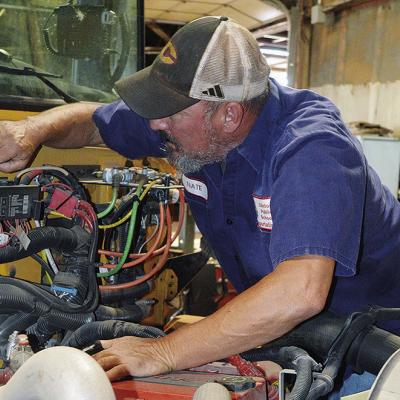 Nate Burnett performs yearly inspections of the school busses at the CPS Bus Barn to ensure they are ready for the new school year. CDN | Christian Jacobsen
