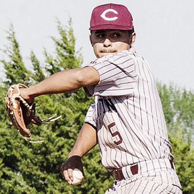 Clinton’s Jesus Gutierrez goes into his wind up as he prepares to pitch the ball during the Reds’ road win over Weatherford Monday in the “Custer County Conflict.” CDN | Sam Goodwyn