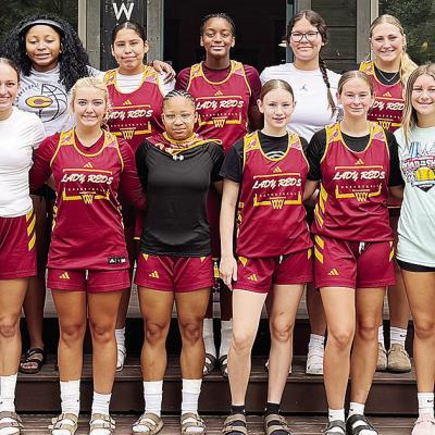 The Clinton Lady Reds basketball team comes together while in Broken Bow for a summer camp. Pictured in front, from left, are Emily De La Rosa, Paisley Ruyle, Laney Anderson, Ale-Jia Lacey, Hannah Miller, Sydney Pugh and Hadley Meget; back, Coach Ashley G