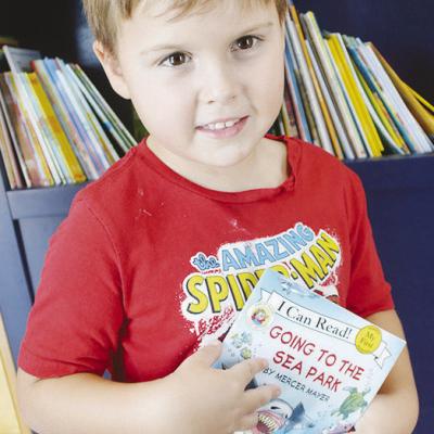 Judah Wagnon decides to select “Going to the Sea Park” as his free book from the Rolling Thunder Book Bus at the Frisco Center. CDN | Christian Jacobsen