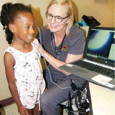 CDN | Robert S. Bryan Kynnedi Jefferson, from Danielle Sawyer’s first-grade class at Nance, gets checked out by school nurse Sheffield Southall. Article Image Alt Text
